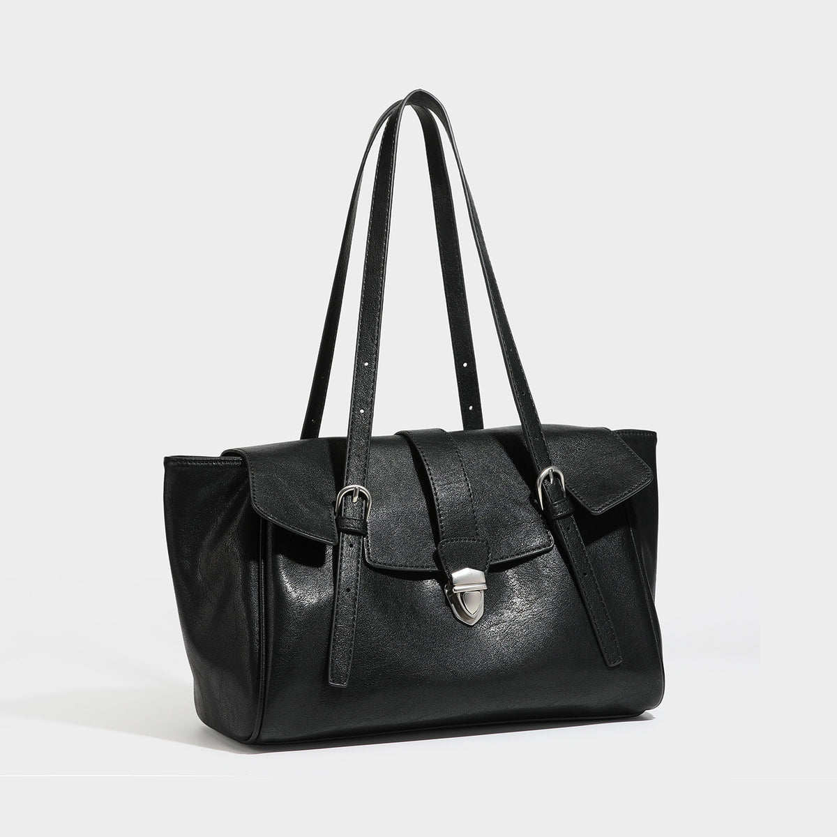 Large structured vintage-style tote bag with flap-front turn-lock closure, twin buckle straps, and double shoulder handles