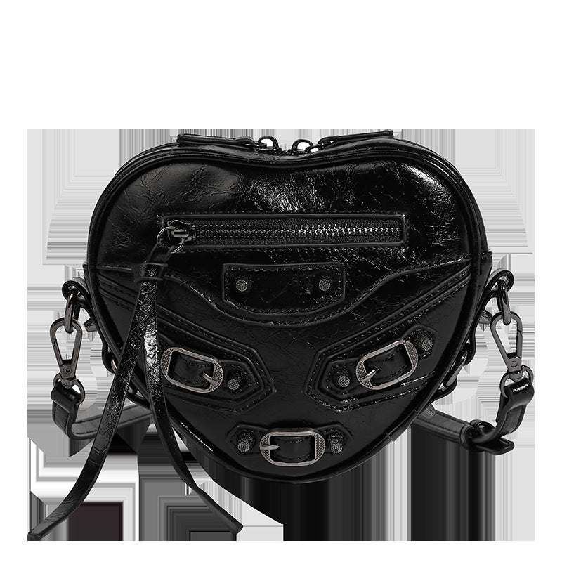 Mini heart-shaped crossbody bag with glossy crinkled finish and moto buckle hardware, detail view 16