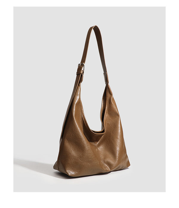 Large slouchy hobo shoulder bag in smooth leather-look finish with adjustable strap and gold-tone hardware, detail view 19