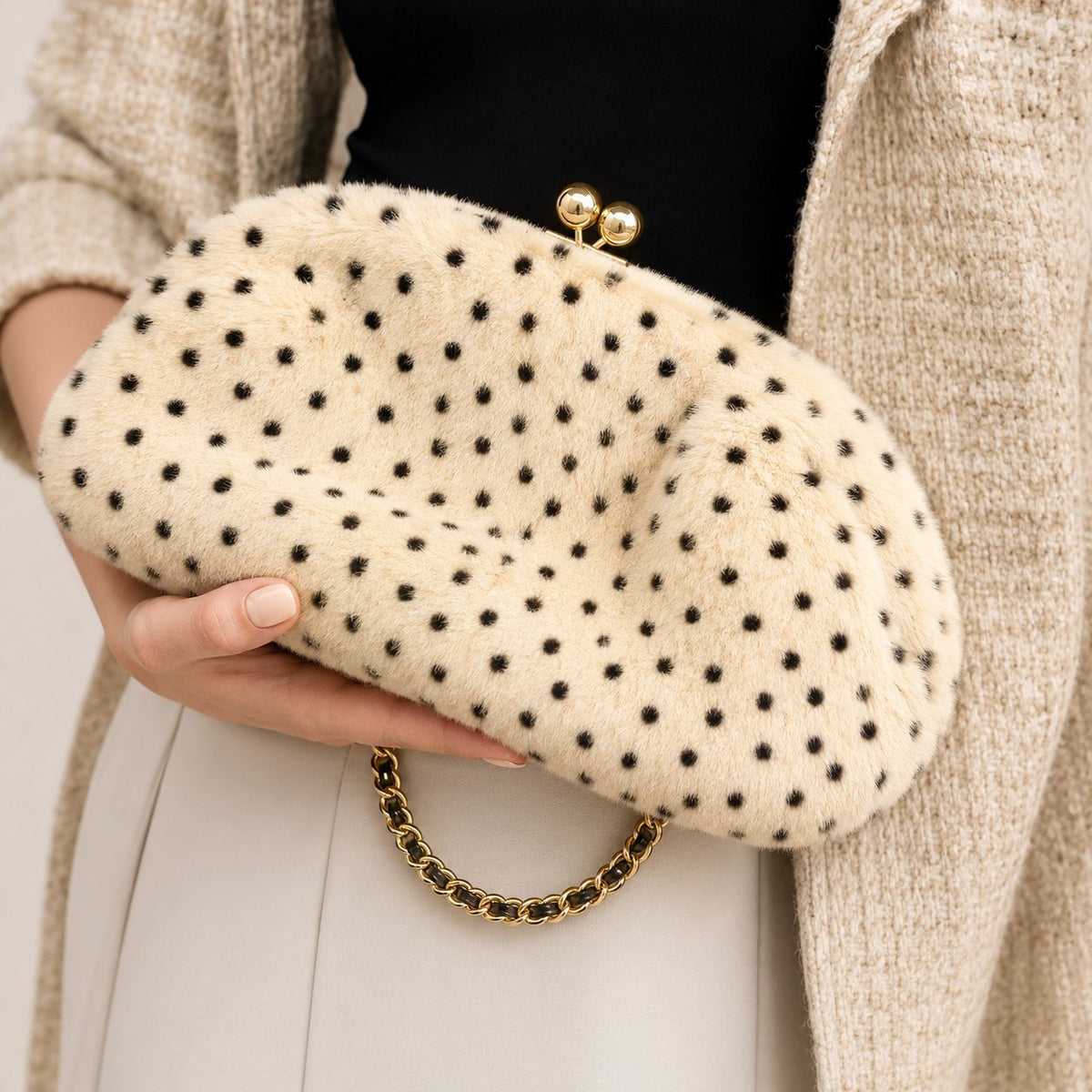 Rounded spotted faux-fur kiss-lock clutch bag with gold-tone chain strap in cream with black dot print, detail view 9