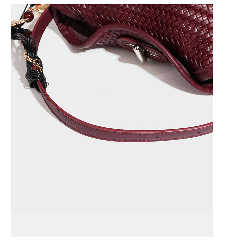 Small woven-look leather-look flap shoulder hobo bag in burgundy with silver-tone hardware and decorative tassel charm