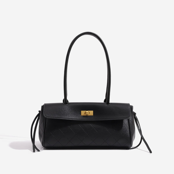 Structured black baguette bag with diamond-quilted front panel, gold-tone turn-lock flap closure, and dual looped top