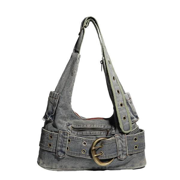 Washed faded denim hobo shoulder bag with wide brass-tone buckle belt panel, eyelet detailing, front zip pocket, and dual