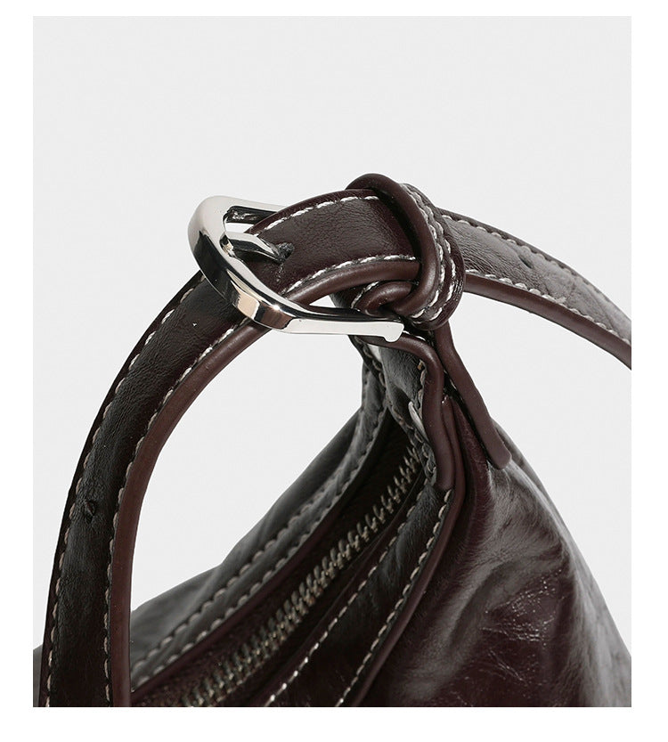 Slouchy hobo shoulder bag in glossy crinkled leather-look finish with zip-top closure and silver-tone ring hardware, detail