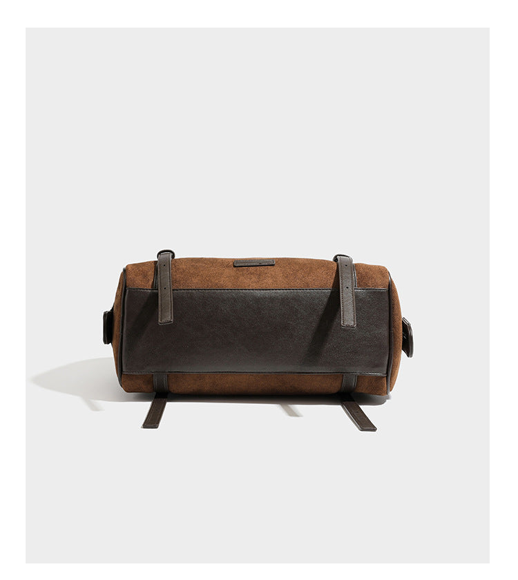 Large brown suede-finish barrel shoulder bag with dark leather-look trim, silver-tone zippers, dual top handles, and long