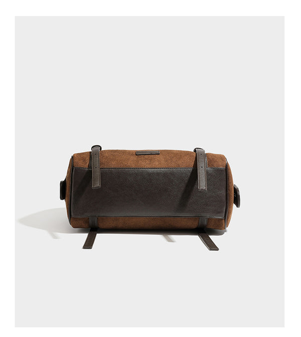 Large brown suede-finish barrel shoulder bag with dark leather-look trim, silver-tone zippers, dual top handles, and long