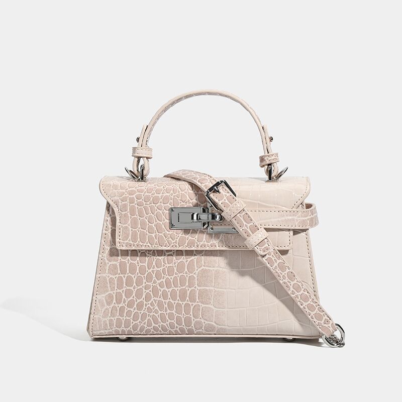 Croc-embossed mini top-handle satchel with silver turn-lock closure and adjustable crossbody strap, front view