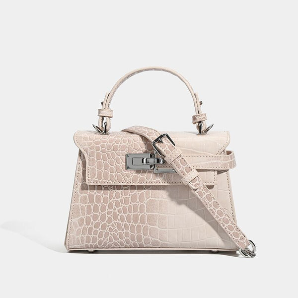 Croc-embossed mini top-handle satchel with silver turn-lock closure and adjustable crossbody strap, front view