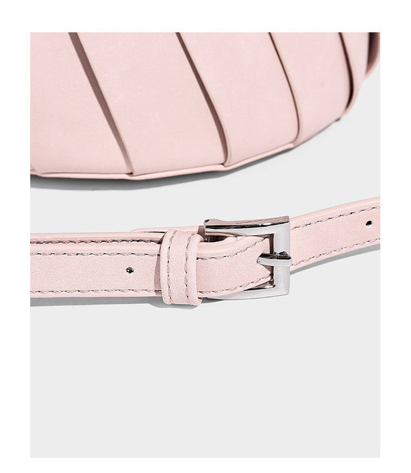 Structured pleated-panel bucket bag with curved top handle and detachable adjustable shoulder strap in smooth matte, detail