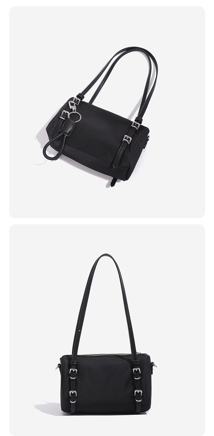 Compact nylon Boston barrel bag with zip-top closure, silver-tone hardware, dual slim handles, and detachable crossbody