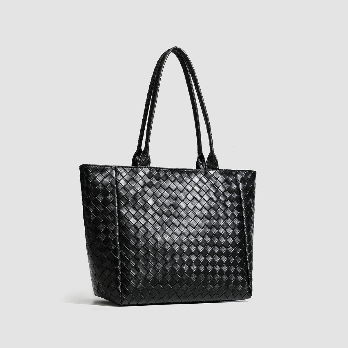 Large structured black woven diamond-pattern tote bag with braided double shoulder straps and glossy leather-look finish