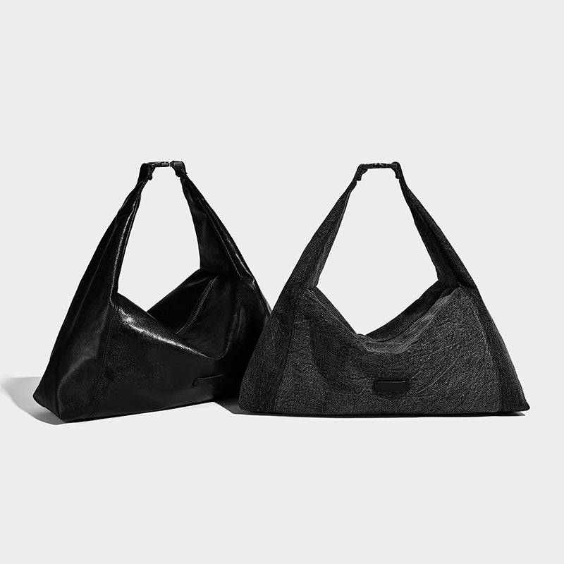 Oversized slouchy denim-look hobo shoulder bag with wide adjustable strap and top zipper closure, detail view 2