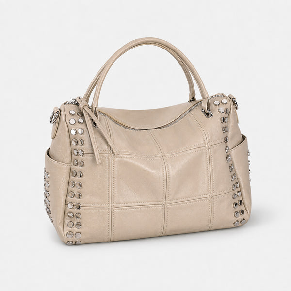 Black leather-look satchel bag with gunmetal rivet trim, grid-stitched paneling, dual rolled top handles, and curved zip