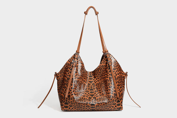 Large leopard print shoulder tote bag with glossy finish, long double straps, front zip pocket, silver-tone hardware, and