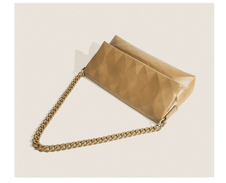 Cream white rectangular flap shoulder bag with geometric faceted surface and chunky tone-on-tone chain strap with gold-tone