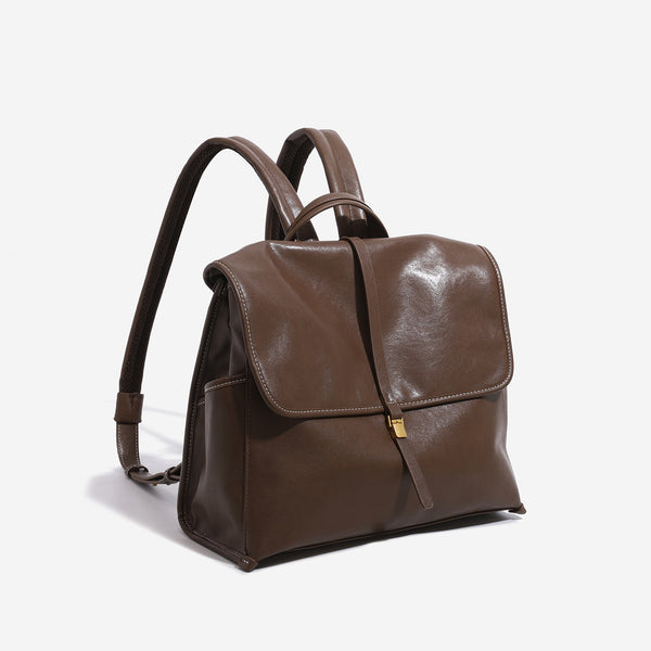 Structured retro flap backpack handbag in brown leather-look finish with gold-tone toggle clasp and top handle, detail view 3
