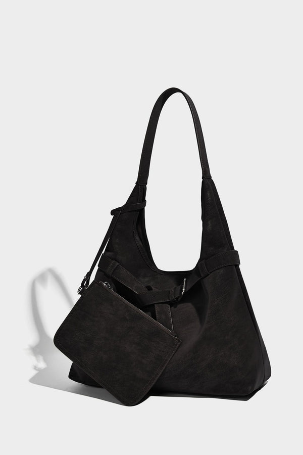 Slouchy oversized shoulder tote bag with matte textured finish, wrap-around buckle strap, and detachable front zip pouch