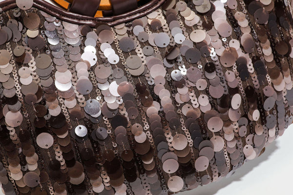 Small sequin half-moon handbag with circular wood-look ring handles and detachable leather-look shoulder strap, detail view