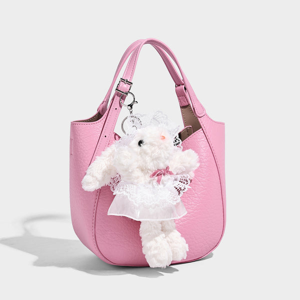 Small pebbled half-moon shoulder bag with dual top handles, detachable crossbody strap, and silver-tone hardware, detail view