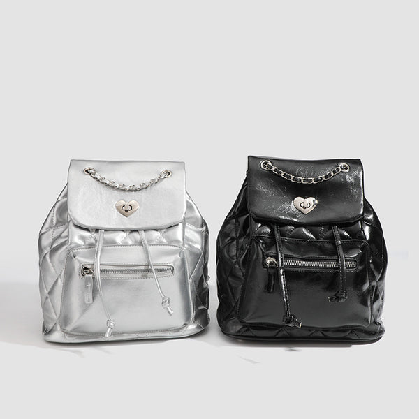 Quilted leather-look backpack with heart turn-lock clasp and woven chain handles, detail view 2