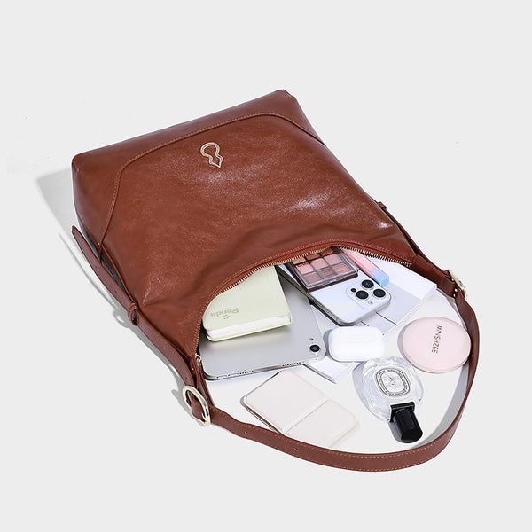 Glossy leather-look slouchy hobo shoulder bag with zip closure, gold-tone hardware, and adjustable strap, detail view 4