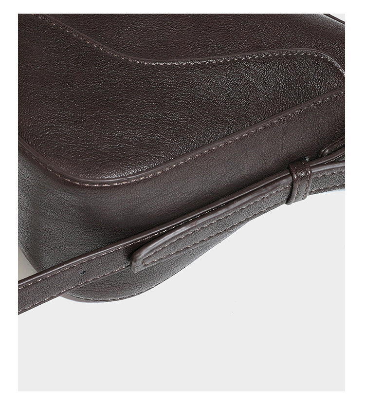 Dark brown curved zip-top hobo shoulder bag with slim adjustable strap and silver-tone hardware, detail view 21