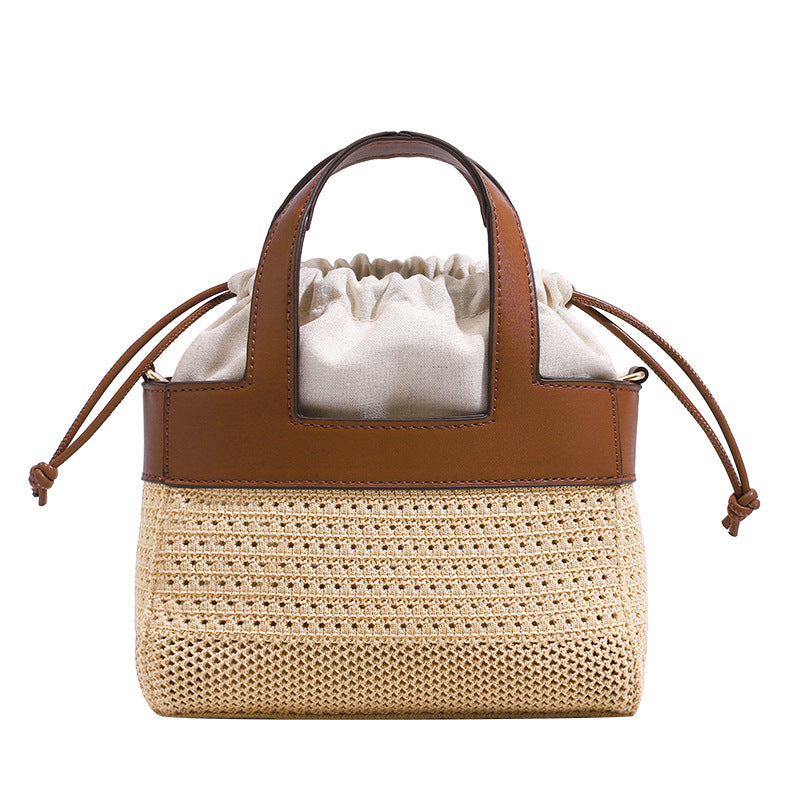 Small woven open-weave bucket bag with brown leather-look trim, cream gathered drawstring lining, dual top handles, and