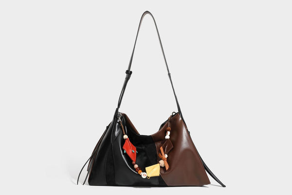 Two-tone black and brown leather-look slouchy shoulder bag with beaded tassel charm and silver-tone hardware, detail view 22
