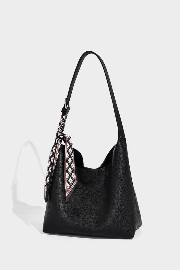 Soft slouchy hobo shoulder bag in pebbled matte finish with slim strap, silver-tone ring hardware, and knotted printed scarf