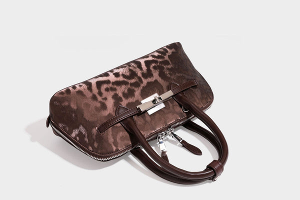 Strukturierte Henkeltasche mit tonal abgestimmtem Leopardenprint, Besatz in Lederoptik, gerollten Henkeln, vorderem Drehverschluss und