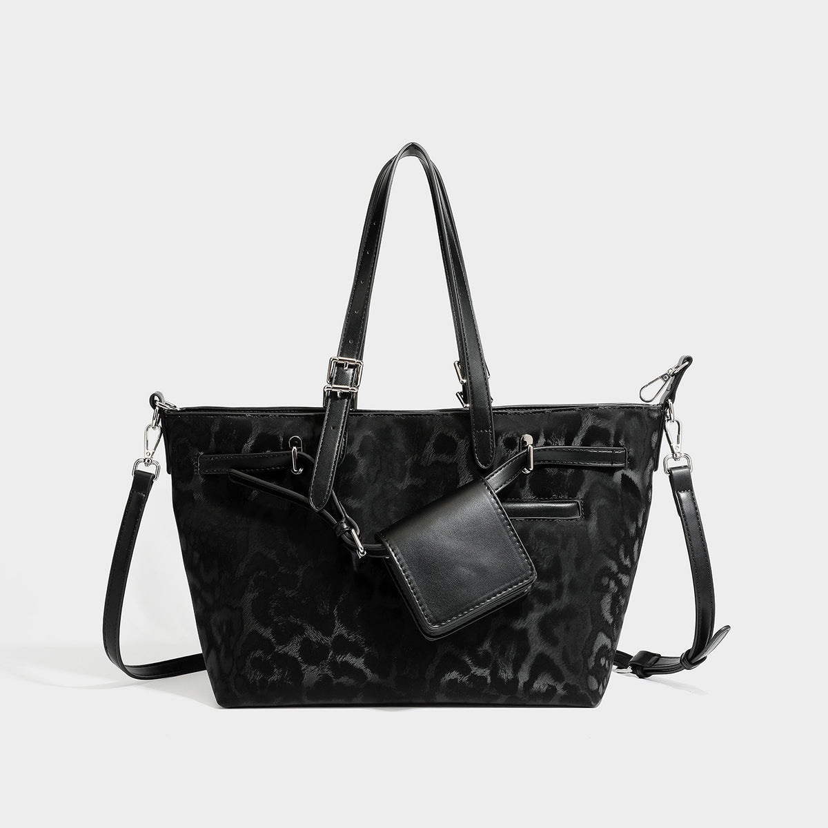Glossy leopard-print tote bag with leather-look dark trim, dual top handles, detachable shoulder strap, and attached front