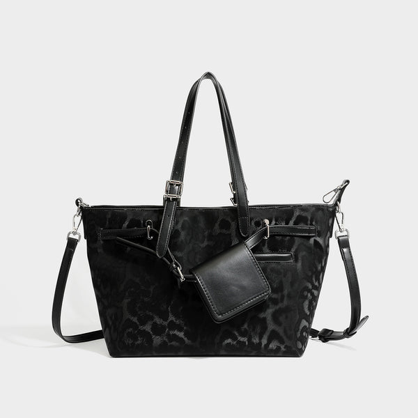 Glossy leopard-print tote bag with leather-look dark trim, dual top handles, detachable shoulder strap, and attached front