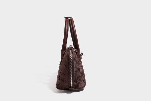 Small structured satchel bag in dark brown velvet-like textured finish with leather-look trim, silver-tone turn-lock bar