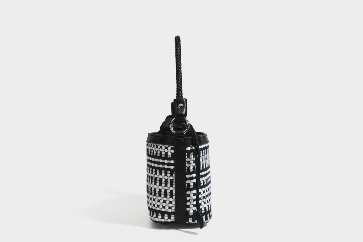Small structured woven checker bucket bag with braided top handle, drawstring closure, and silver-tone hardware in black