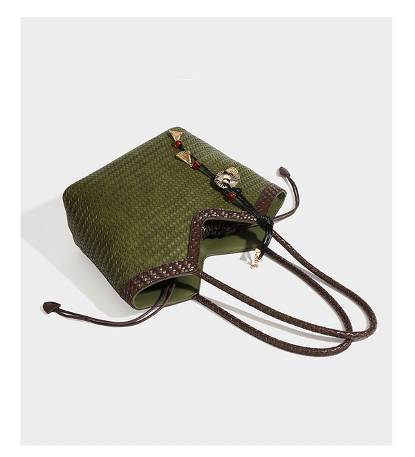 Woven tote bag with braided shoulder straps, drawstring closure, and dangling metal-and-bead charm, detail view 18