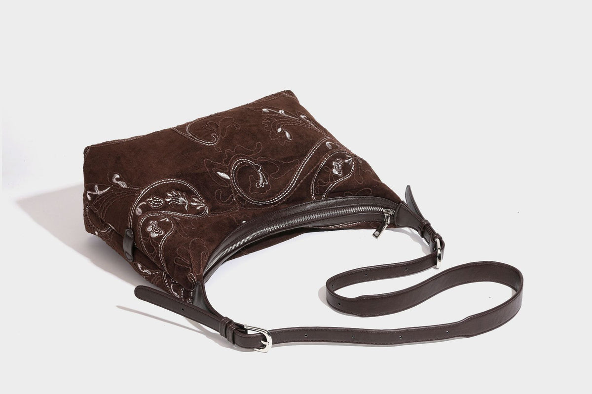 Deep chocolate suede-look hobo shoulder bag with tonal paisley floral embroidery, smooth dark leather-look trim, top zip