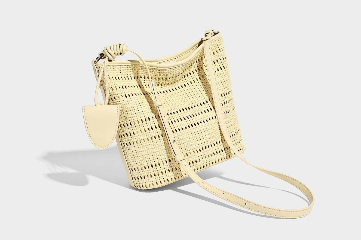 Handwoven open-weave shoulder bag with leather-look trim, knotted adjustable strap, and clip-on sunglasses sleeve pouch