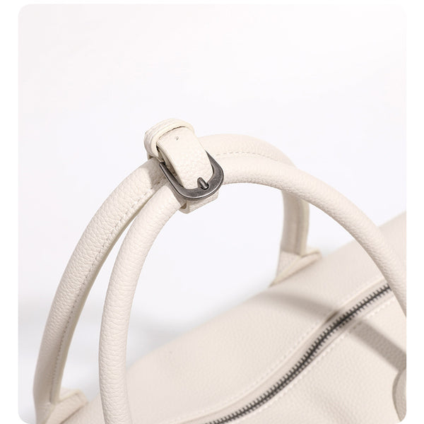 Large cream white pebbled leather-look barrel travel bag with twin top handles, chunky chain shoulder strap, front zip
