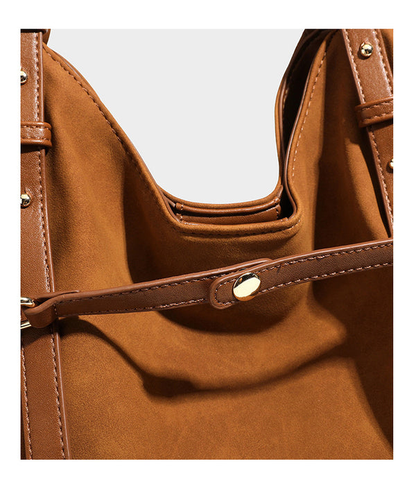 Oversized suede-finish tote shoulder bag in caramel brown with slim leather-look straps and gold-tone logo hardware, detail