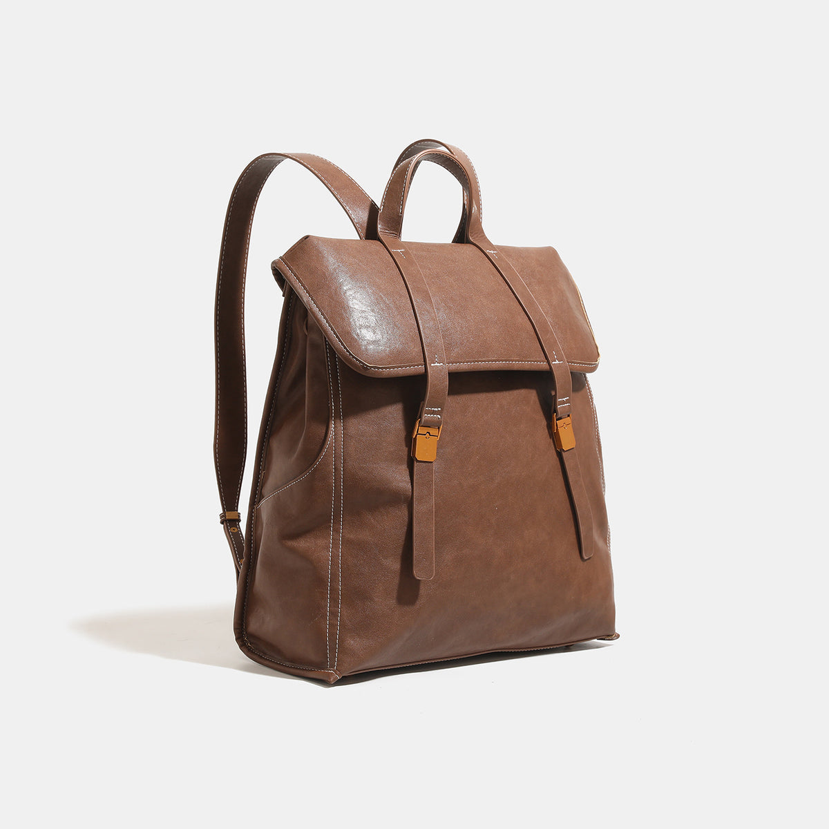 Structured leather-look flap backpack handbag with top handle, buckle front straps, white contrast stitching, and gold-tone