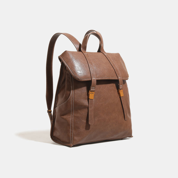 Structured leather-look flap backpack handbag with top handle, buckle front straps, white contrast stitching, and gold-tone