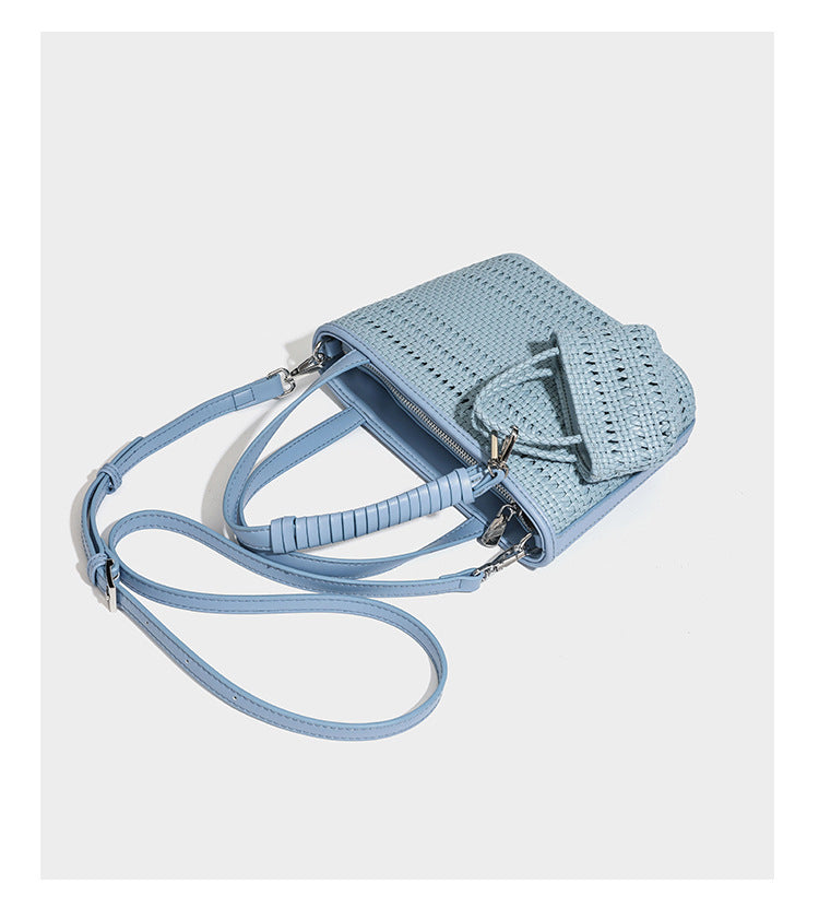 Structured open-weave tote bag with smooth leather-look trim, double top handles, detachable crossbody strap, and mini zip