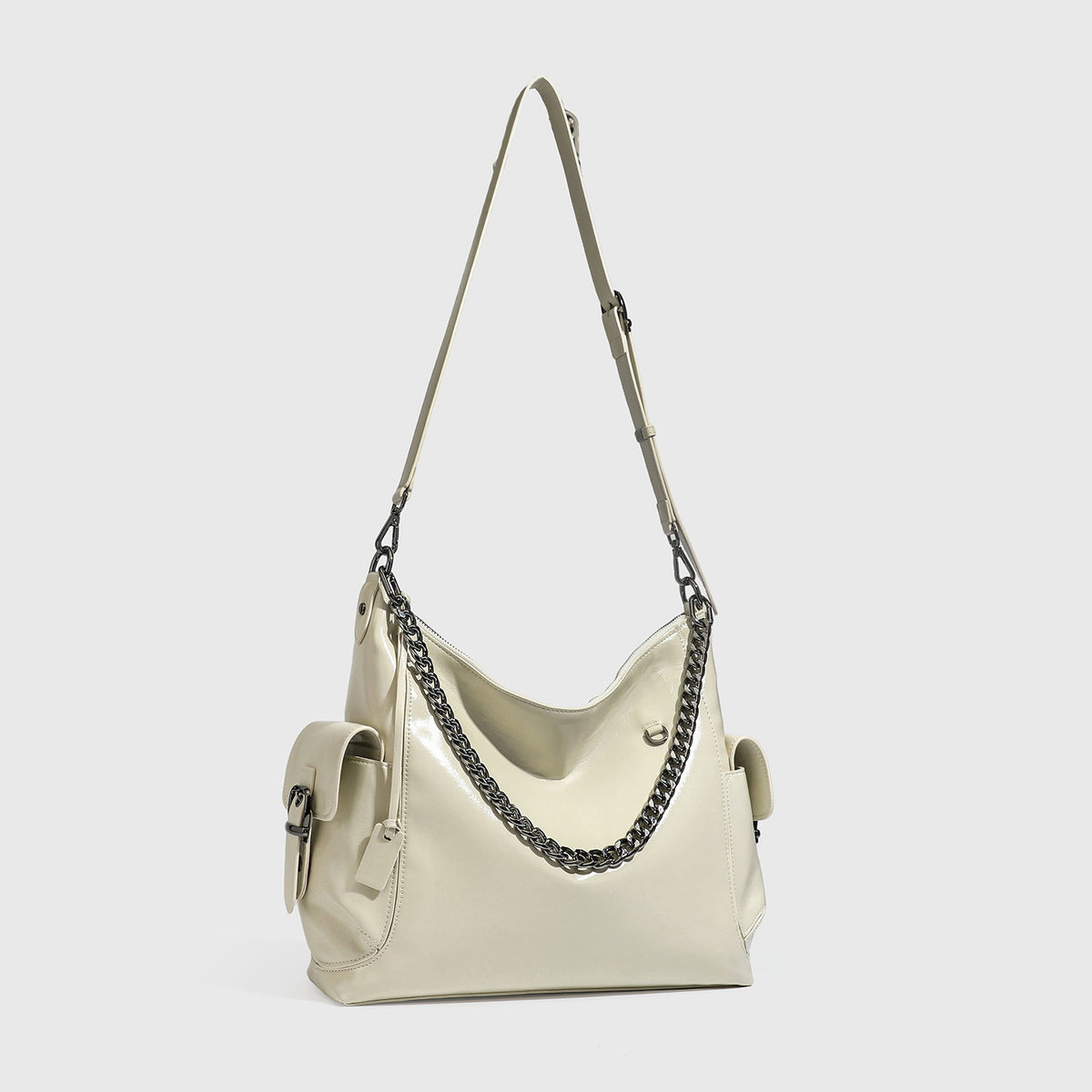 Slouchy hobo shoulder bag with glossy leather-look finish, silver-tone chain drape across front, side buckle pockets, and