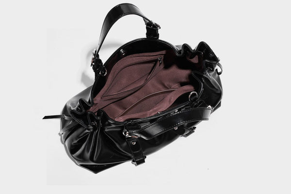 Glossy patent-look slouchy tote bag with ruched drawstring sides, dual top handles, silver ring hardware, and detachable