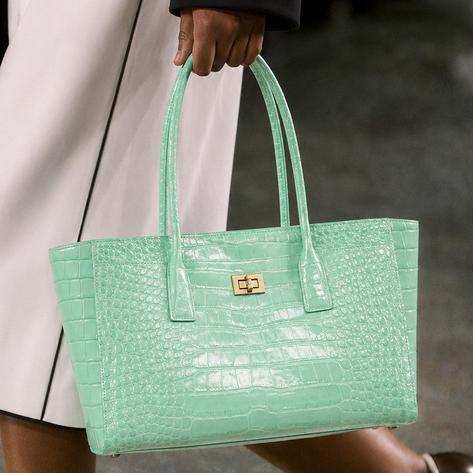 Structured glossy crocodile-embossed tote bag with gold-tone turn-lock closure and double top handles, front view