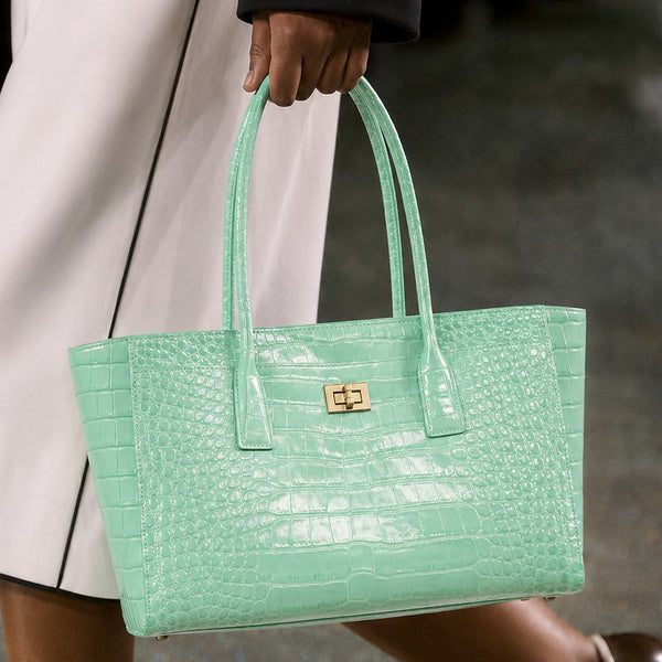 Structured glossy crocodile-embossed tote bag with gold-tone turn-lock closure and double top handles, front view
