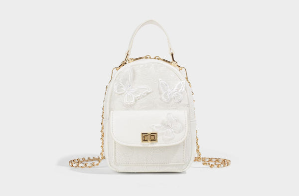 Structured mini backpack handbag with butterfly embroidery, gold-tone chain strap, and turn-lock front flap pocket, detail