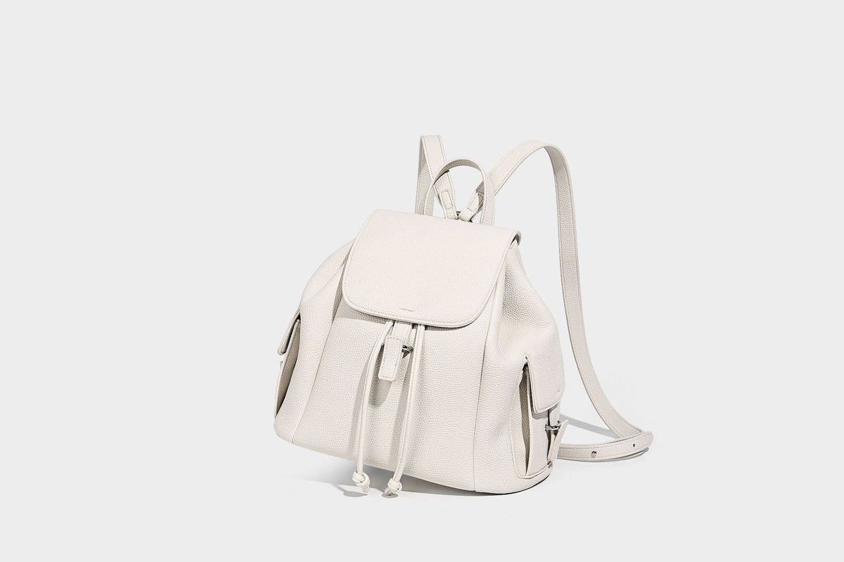 Compact pebbled leather-look flap drawstring backpack handbag with side pockets, top handle, and silver-tone hardware, detail