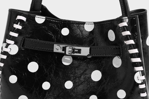 Glänzende, geknautschte Beuteltasche mit Polka-Dots, silberfarbenen Schnallenbeschlägen, kontrastierendem seitlichem Schnürbesatz, Tragegriff und abnehmbarem