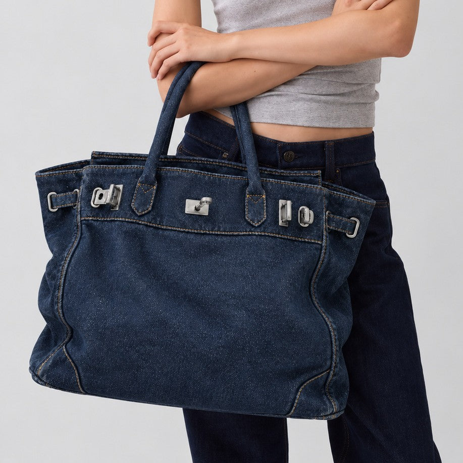 Slouchy denim tote bag with silver-tone turn-lock and buckle hardware and dual rolled handles, detail view 2